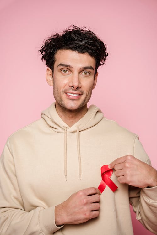 Man In A Hoodie Holding Red Ribbon