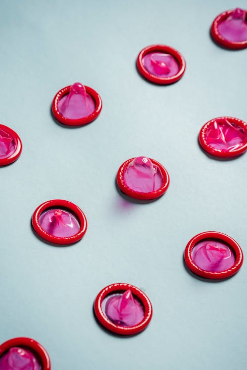 Pink Condoms on White Background