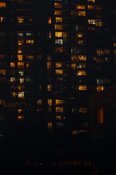 A vibrant view of a skyscraper in Toronto with illuminated windows at night.