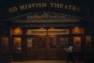 A Woman Walking in Front of the Ed Mirvish Theatre