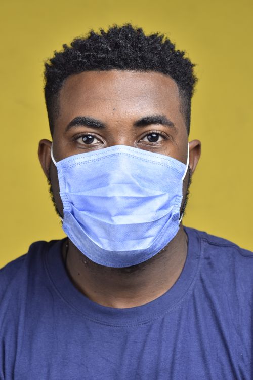 Free Close-up portrait of an African man wearing a protective face mask to ensure safety during the pandemic. Stock Photo