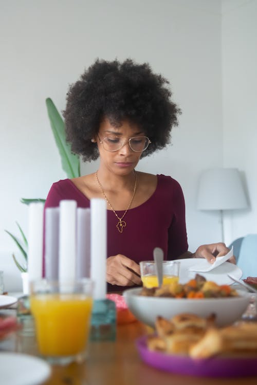Free A Woman Sitting at the Table Stock Photo