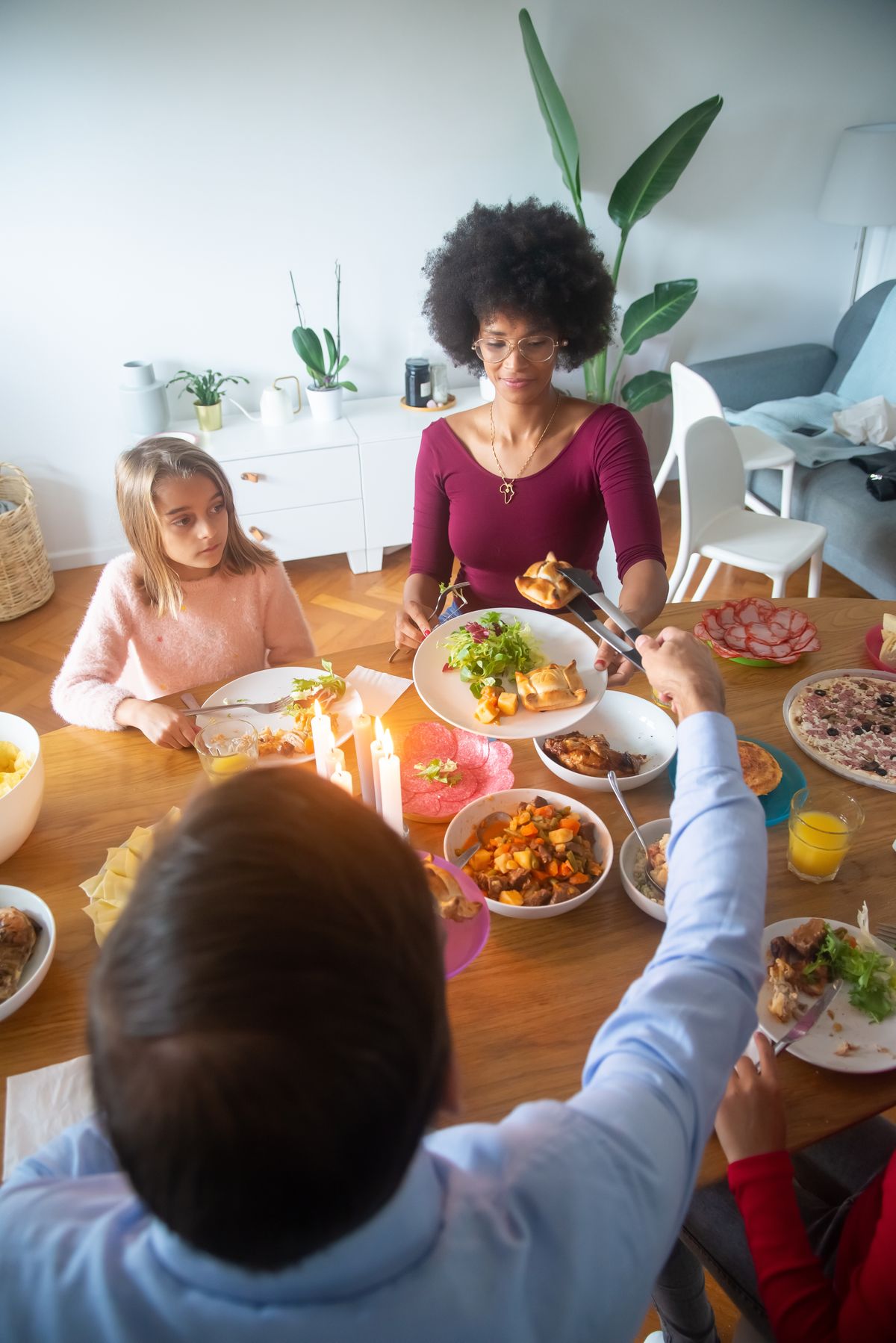 Thanksgiving kids table ideas with a warm family dinner scene with candles for a warm autumn kids table
