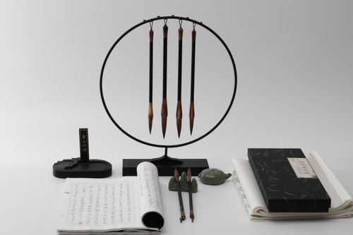 Free A stylish still life showcasing traditional Chinese calligraphy brushes and paper, set against a white background. Stock Photo