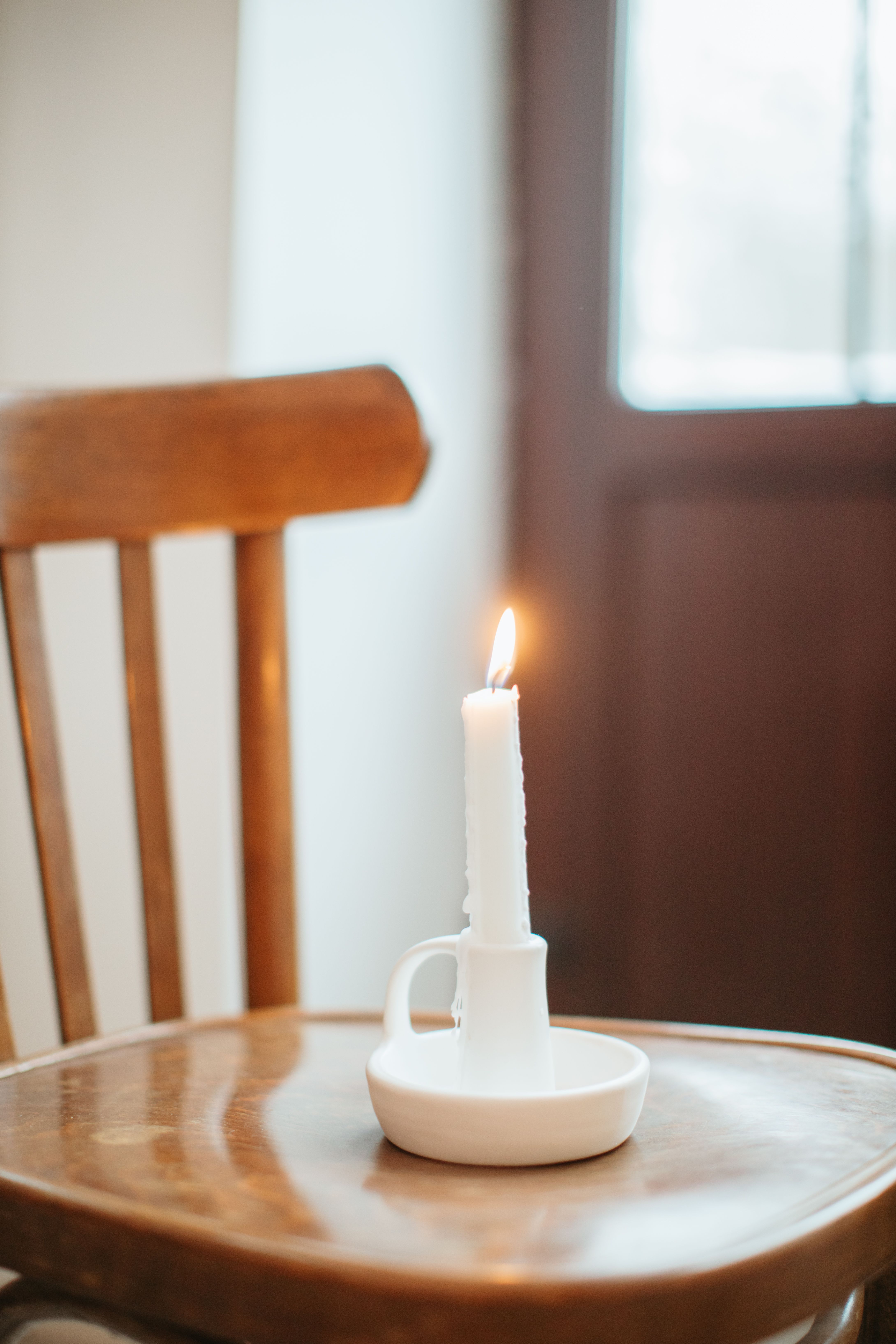 A Lighted Candle on a Chair · Free Stock Photo