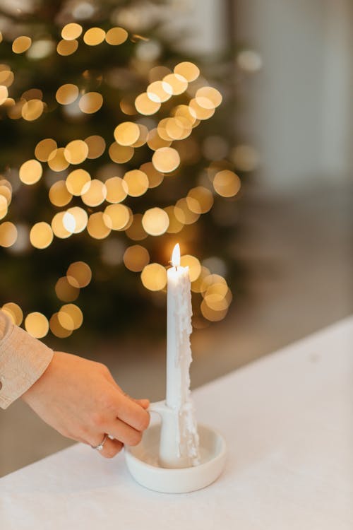 Person Holding Lighted Candle 