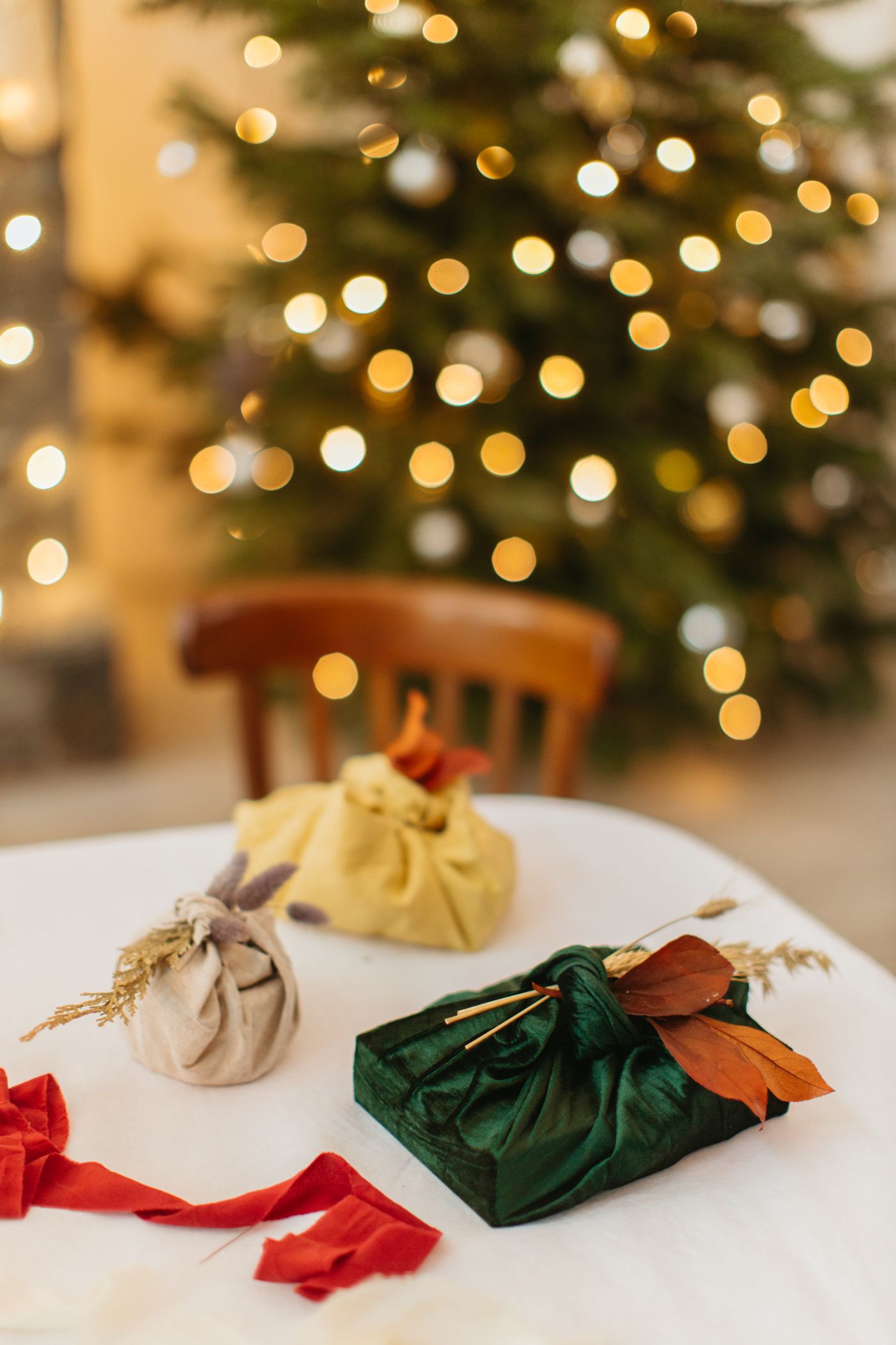 Eco-friendly cloth gift wrapping laid out on a table