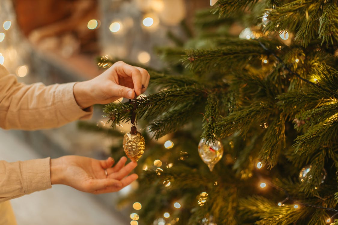 Person Holding Gold Christmas Bauble · Free Stock Photo