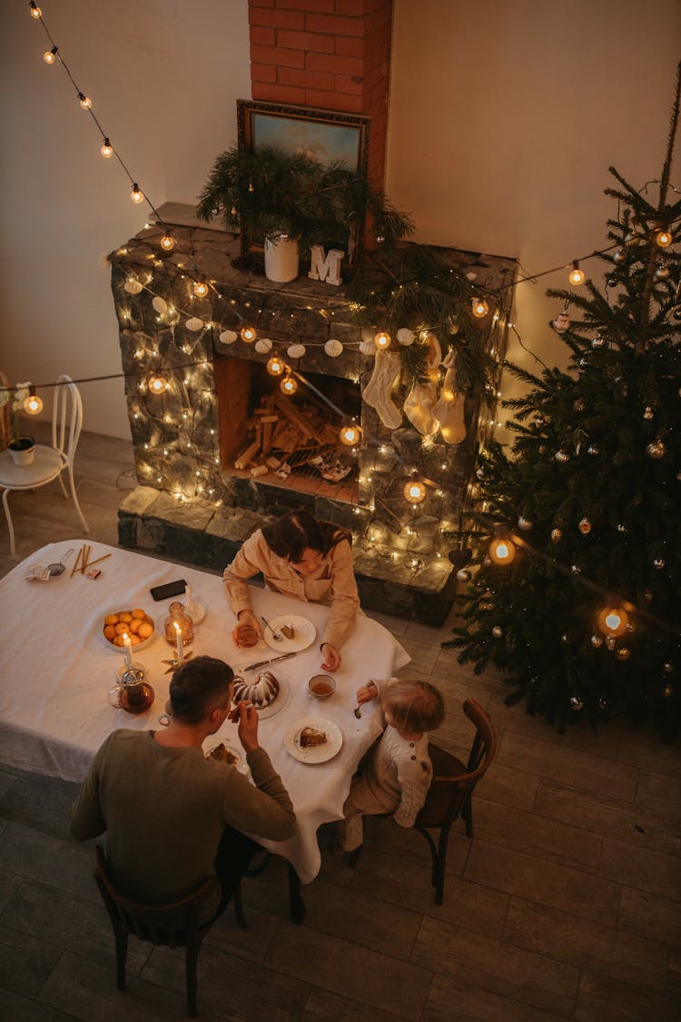 High Angle Shot Of A Family On A Dinner Table During Christmas Season 