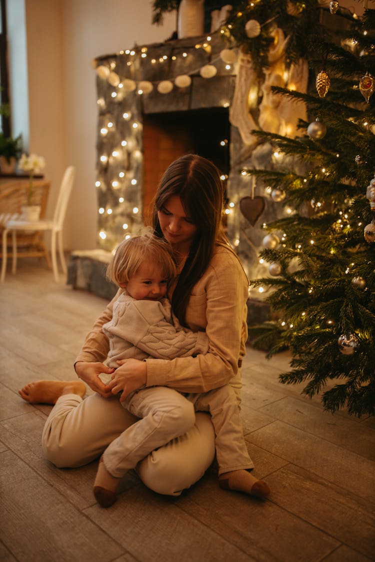 A Kid Sitting On The Woman's Lap 