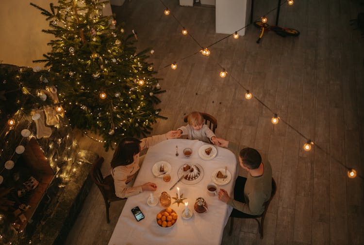 High Angle Shot Of People Sitting On Dining Table