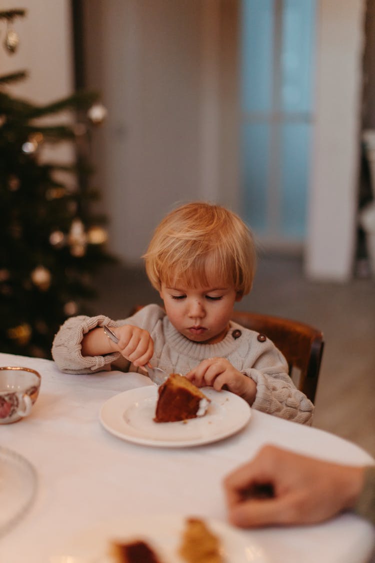 A Boy Eating A Cake 