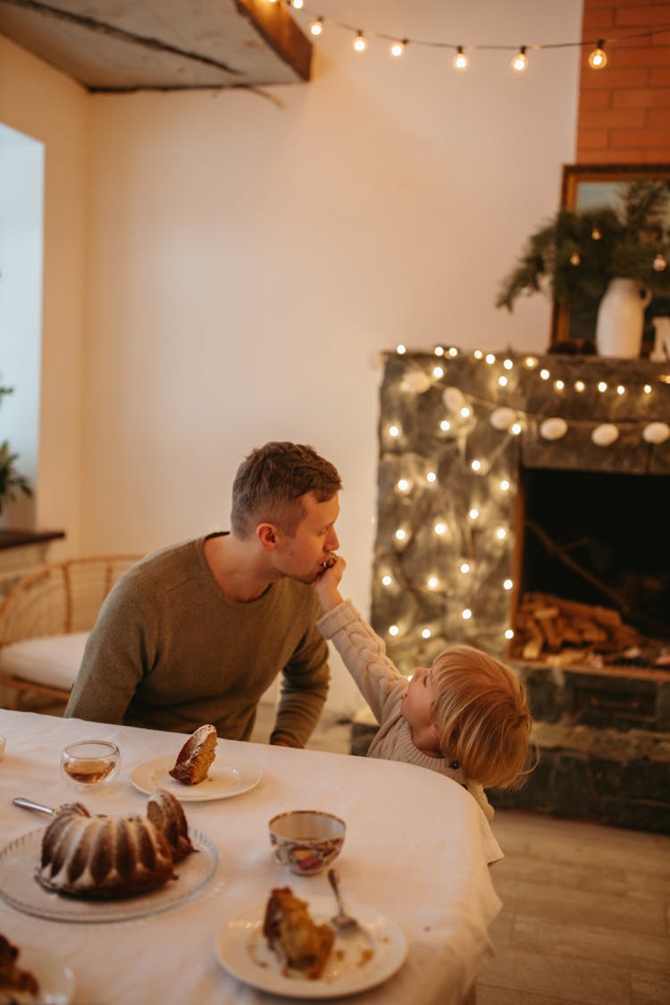 A Blond Boy Feeding His Father 