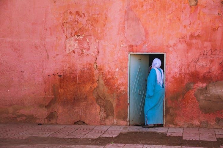 Unrecognizable Indigenous Woman In Hijab Standing Ind Doorway Of Old House