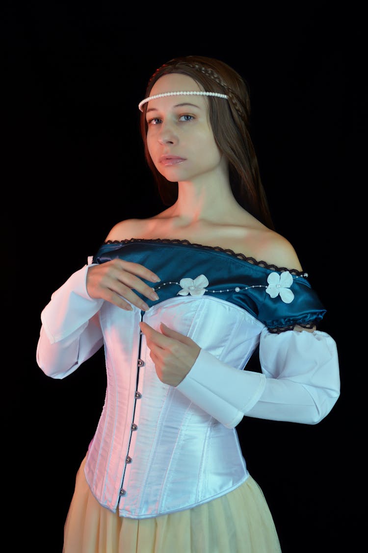 Graceful Young Woman In Elegant Medieval Costume Looking At Camera