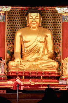 A majestic golden Buddha statue inside a South Korean temple, showcasing intricate artistry and spiritual ambiance.