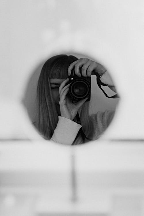 Monochrome Photo of Woman taking Picture