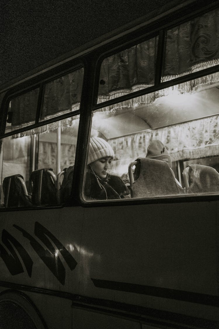 Grayscale Photo Of Woman Riding Bus 