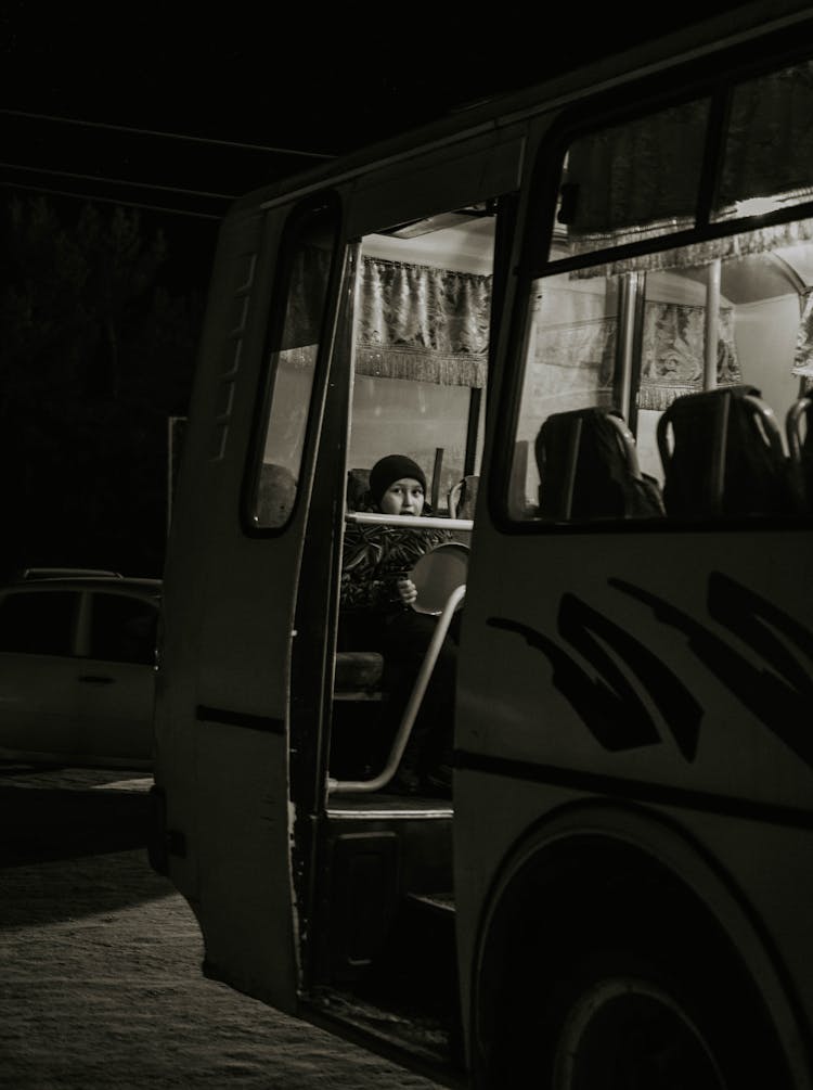 A Child Sitting In A Bus