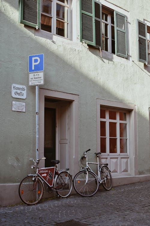 Bicycles Parked Leaning Against a Building Wall 