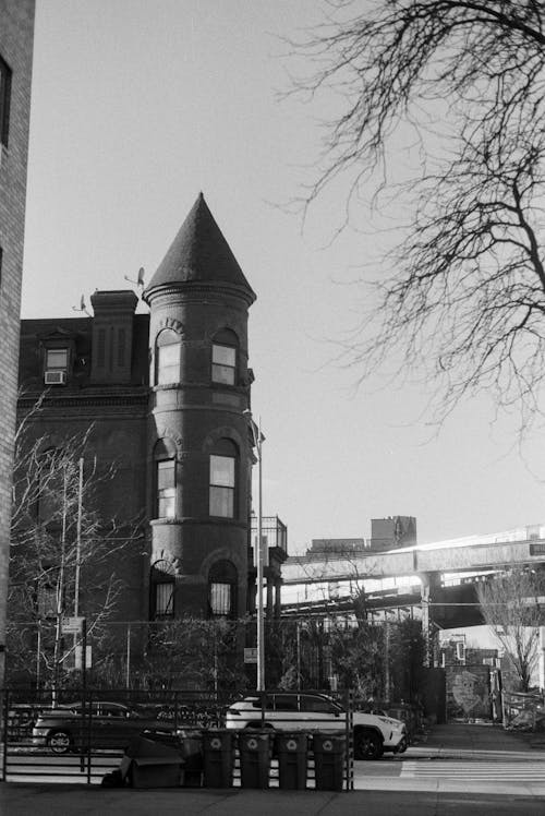 Grayscale Photo of Building Beside Road