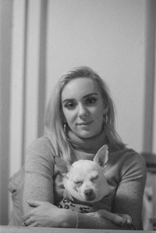 Monochrome Shot of a Woman in Sweater Holding a Chihuahua