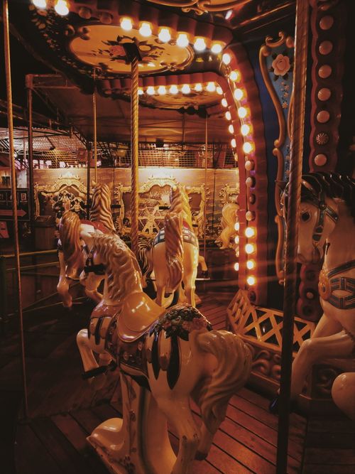 Free A nostalgic carousel ride with vintage horses beautifully lit at night in Batu, Indonesia. Stock Photo