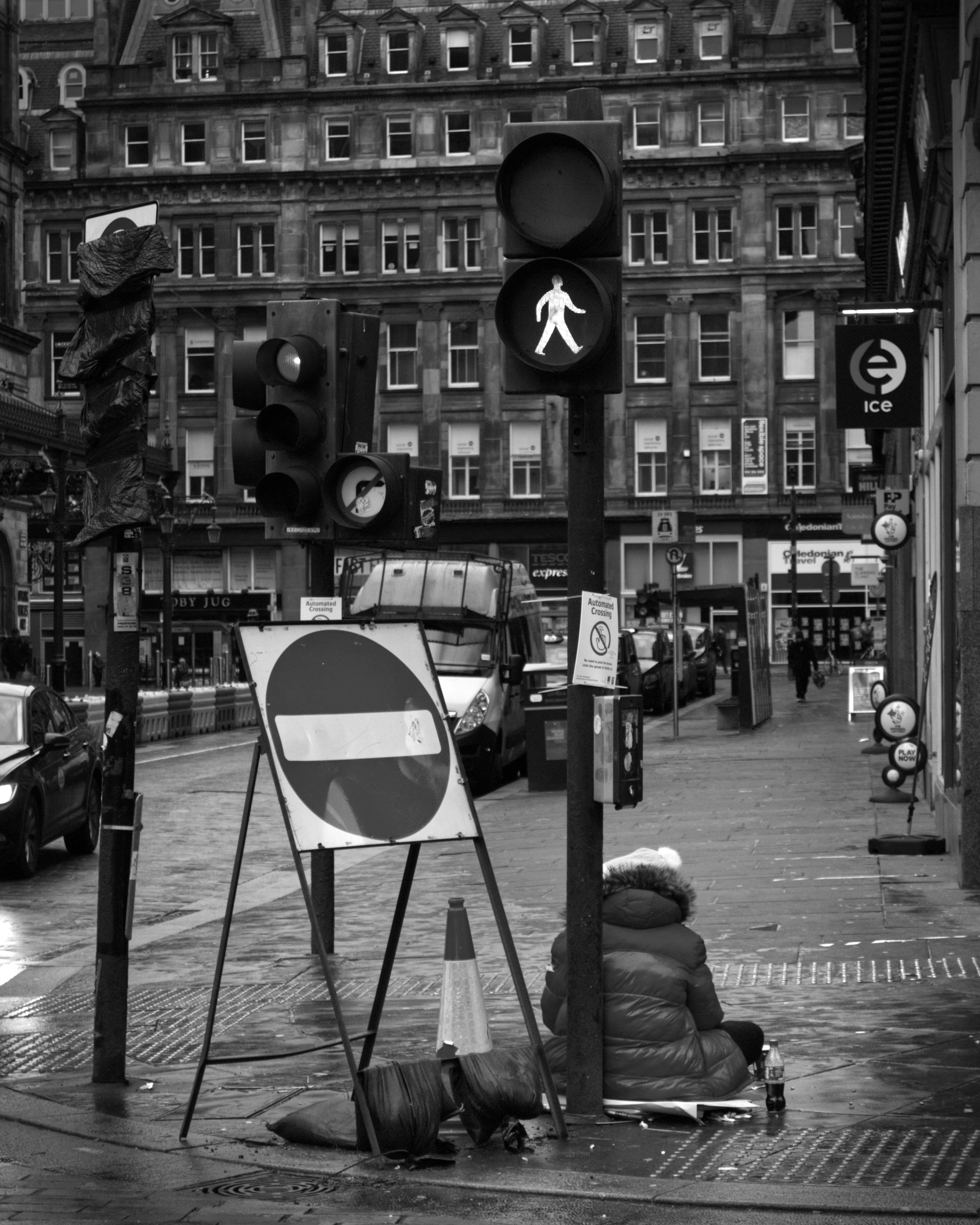 Free Monochrome city street scene featuring traffic lights and a pedestrian crossing sign. Stock Photo