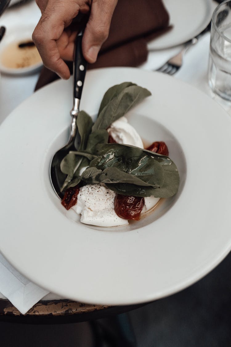 Crop Man Eating Tasty Salad With Burrata Cheese And Tomatoes