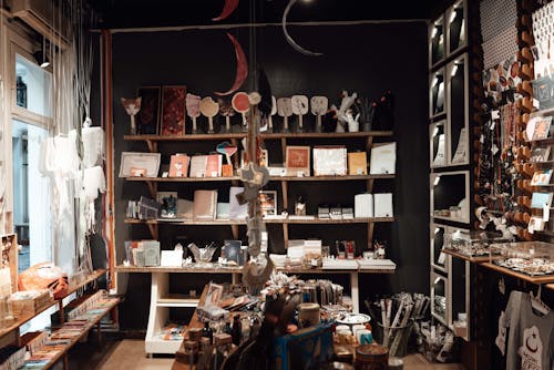 Aged souvenir shop with various gifts and vintage goods placed on wooden shelves