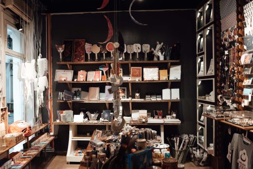 Wooden shelves of a traditional general store filled with vintage goods and trinkets