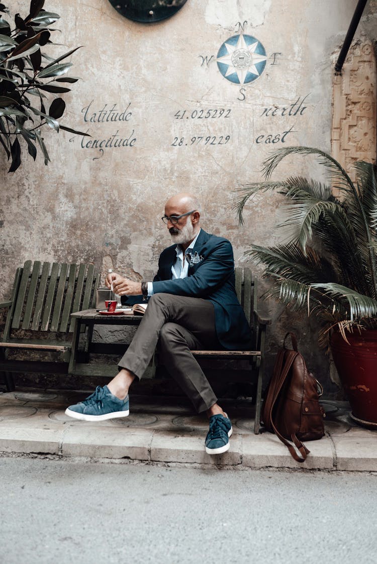 Stylish Senior Ethnic Man Drinking Coffee In Street Cafe