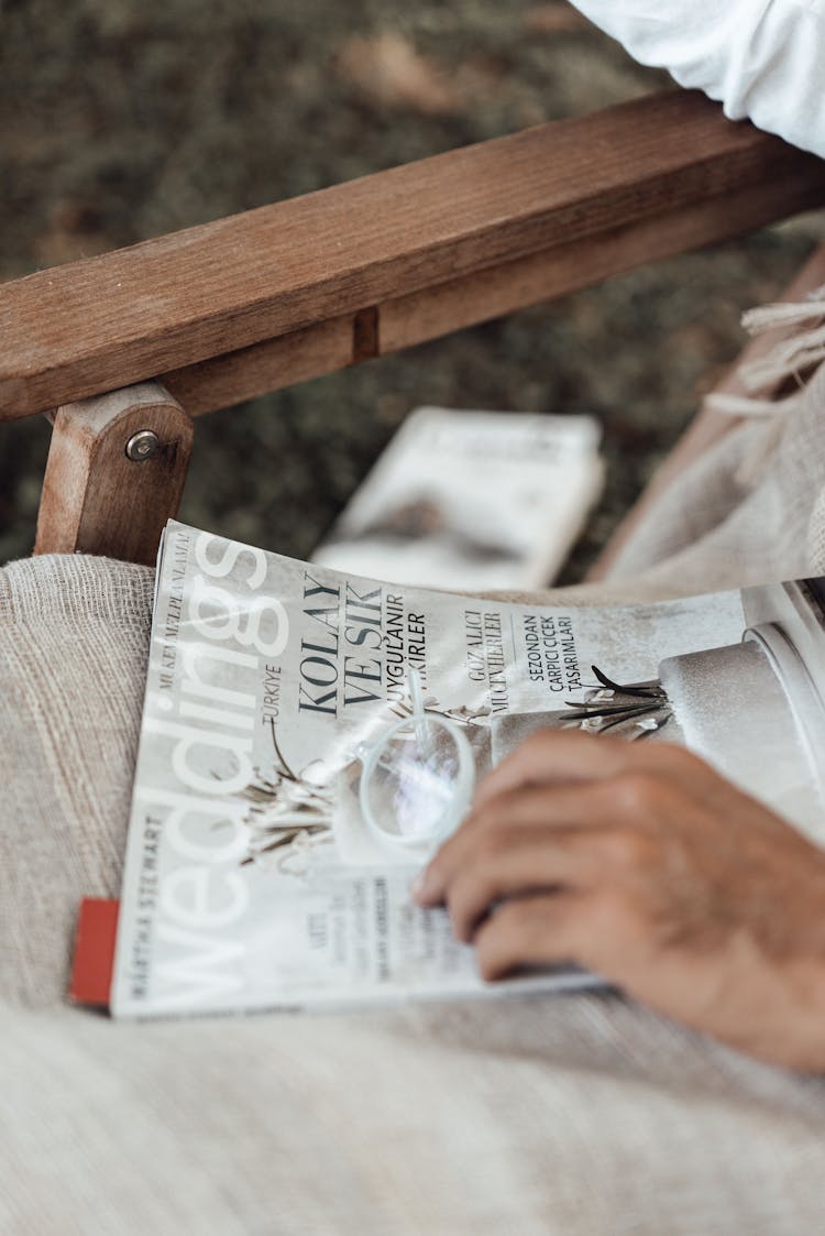 Faceless Man In Chair With Magazine