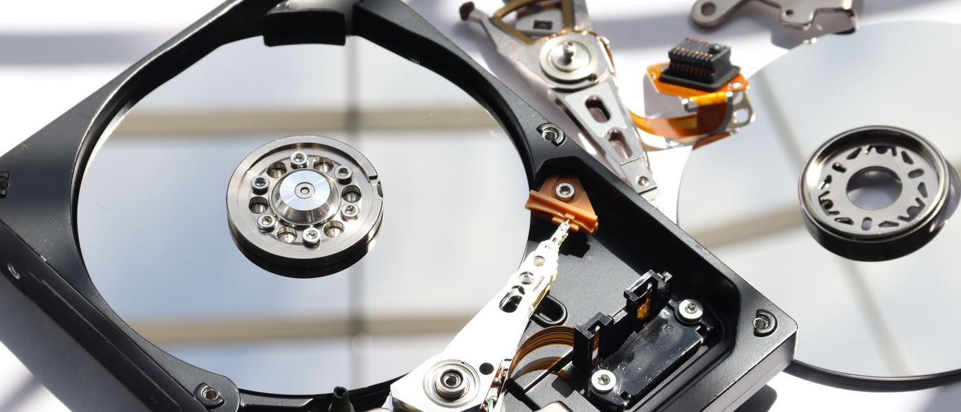 IT professionals managing data recovery and business continuity plan for SMBs in a cloud environment with graphs and servers.