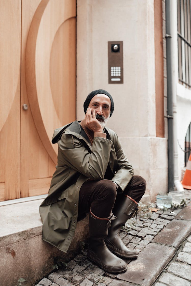 Mature Hispanic Man Touching Face In Town