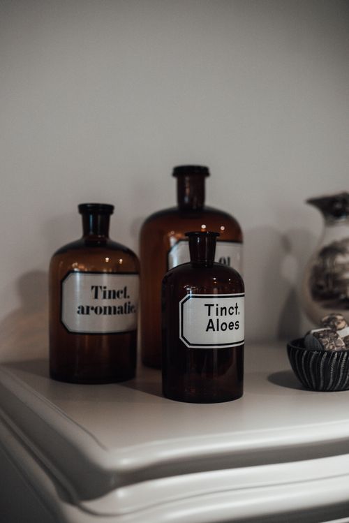 Free Set of bottles with various tinctures and aromatic essential oils placed on shelf in store Stock Photo