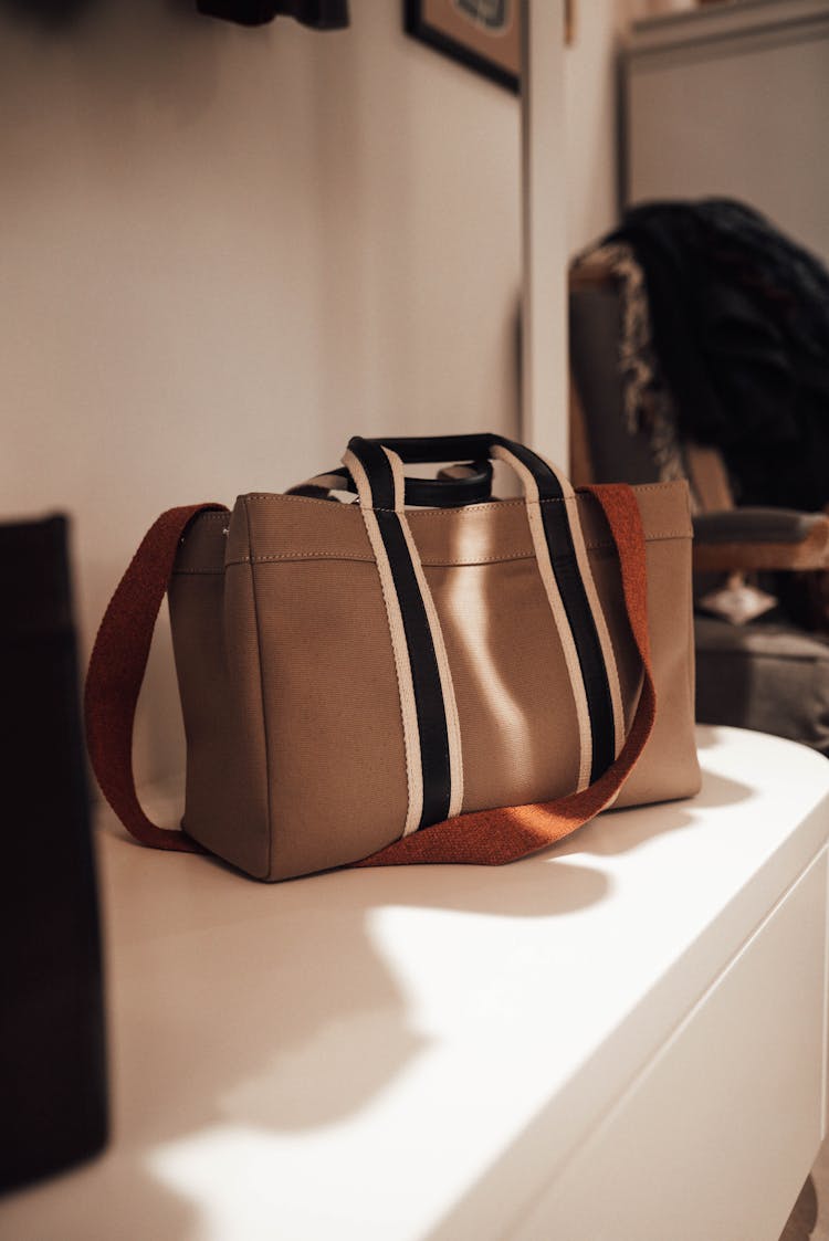 Fashionable Handbag Placed On Shelf In Modern Store