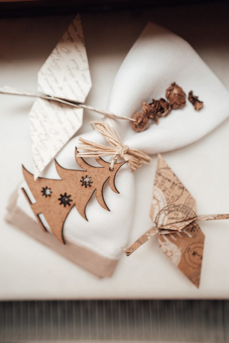 Napkin With Decorative Fir Near Origami Cranes On Textile