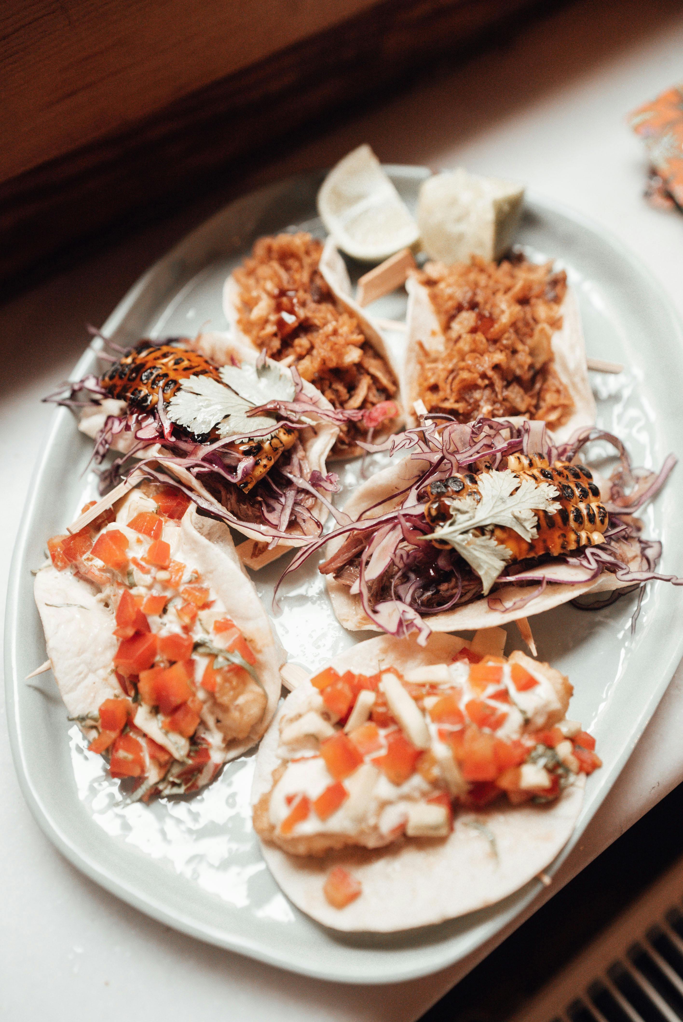 tacos with different ingredients on plate on windowsill in apartment