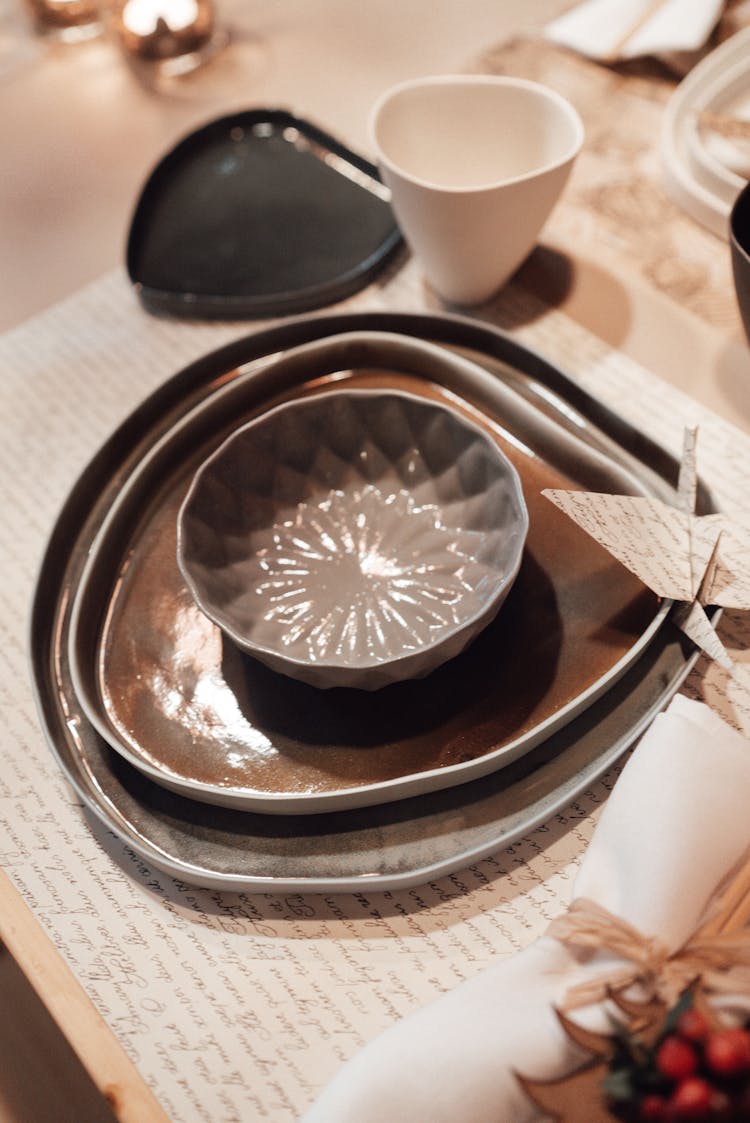 Utensil Near Origami Crane On Table Near Cup And Napkin