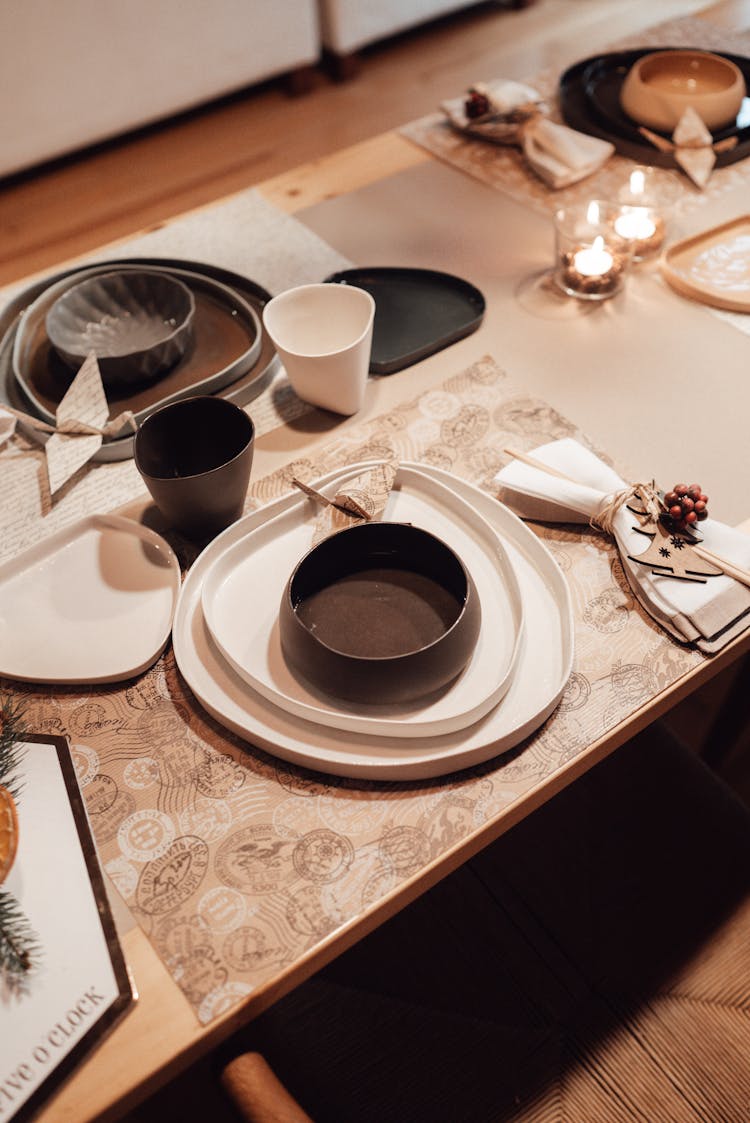 Table With Dinnerware And Origami Crane Near Napkins And Cups