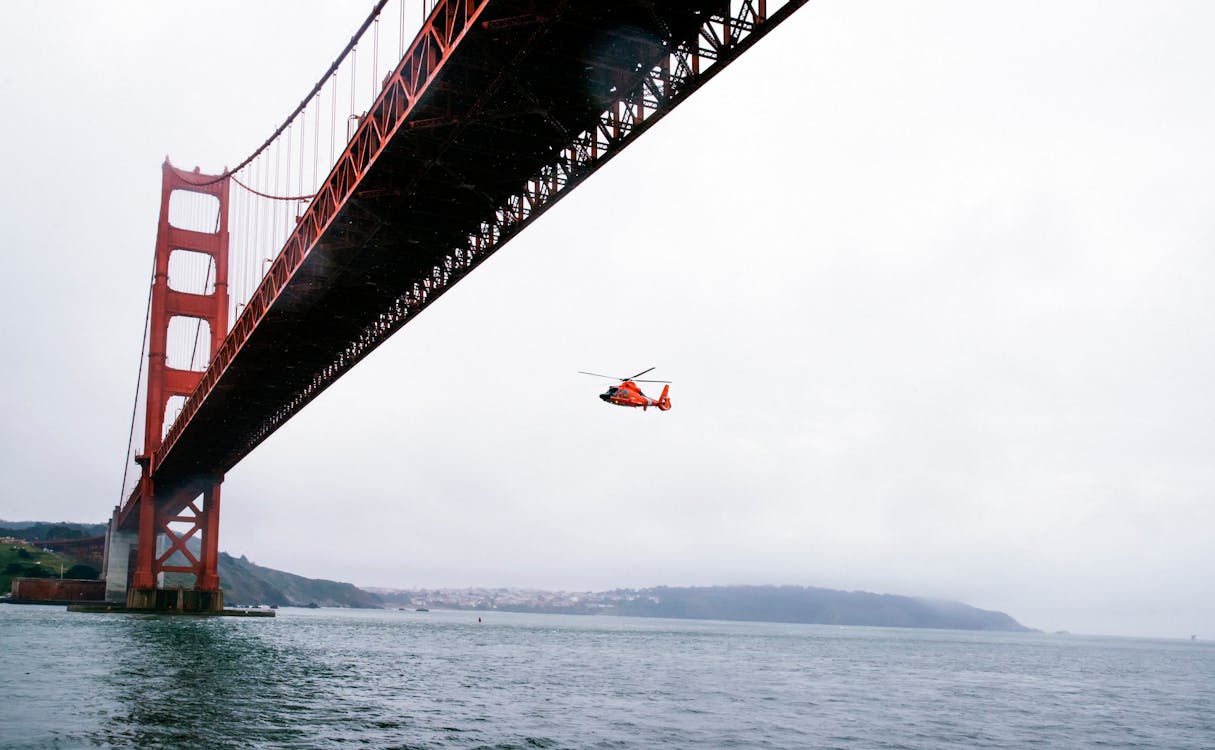 Free Rescue Helicopter Flying Under Golden Gate Bridge Stock Photo