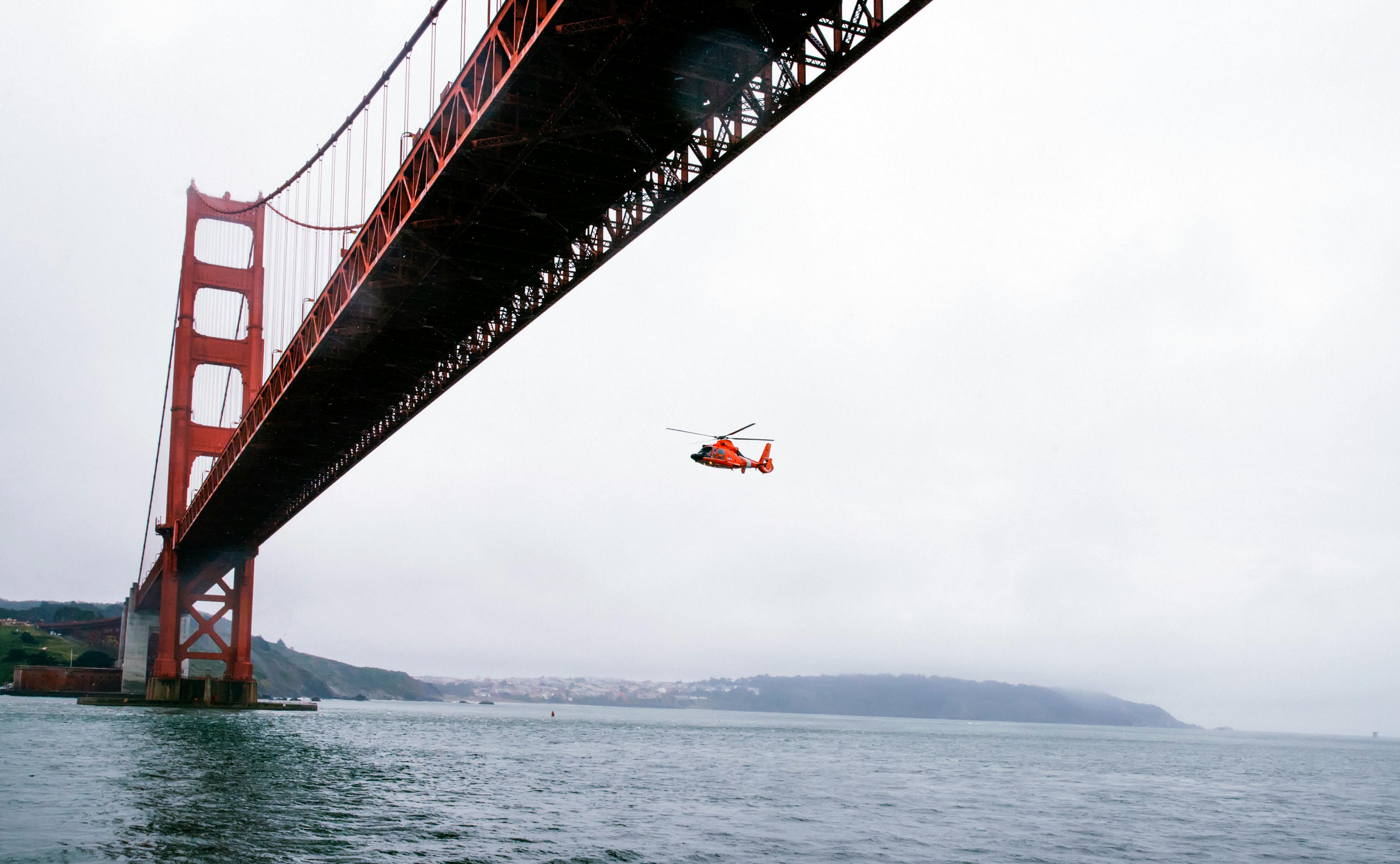 Rescue Helicopter Flying Under Golden Gate Bridge · Free Stock Photo