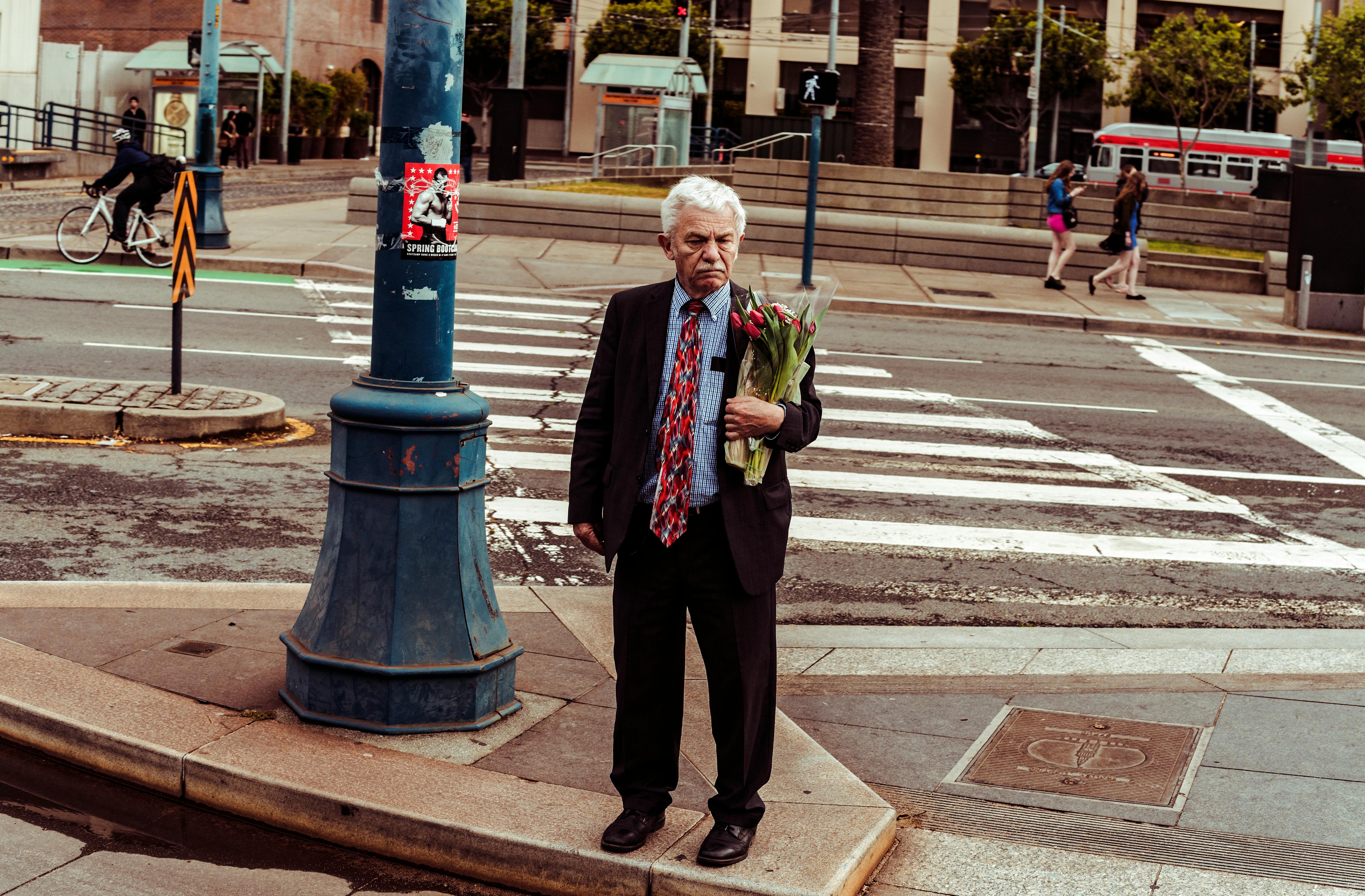 Man Holding Bouquet of Red Roses