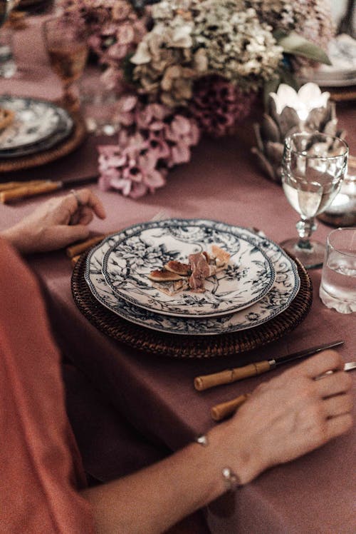 Woman sitting at table with plates at festive event