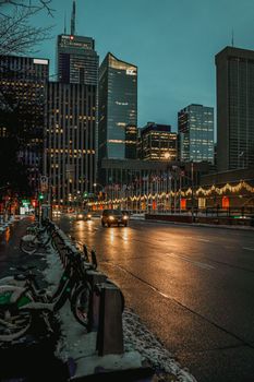 Illuminated skyscrapers and street at night in Toronto, Canada.