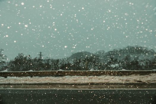 Snow falling heavily on a Toronto highway during winter, capturing the serene and cold atmosphere.