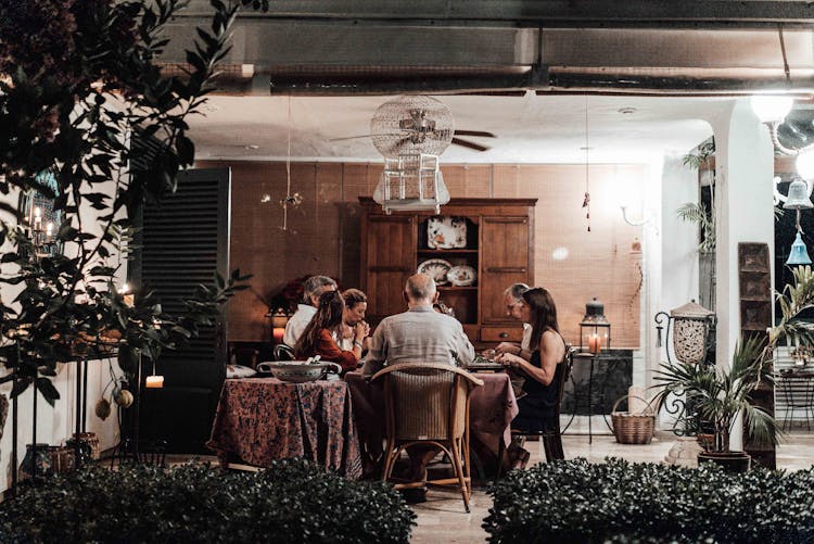 Family Having Dinner In Dining Room