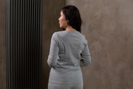 Calm woman standing in modern apartment