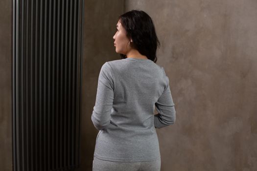 Calm woman standing in modern apartment